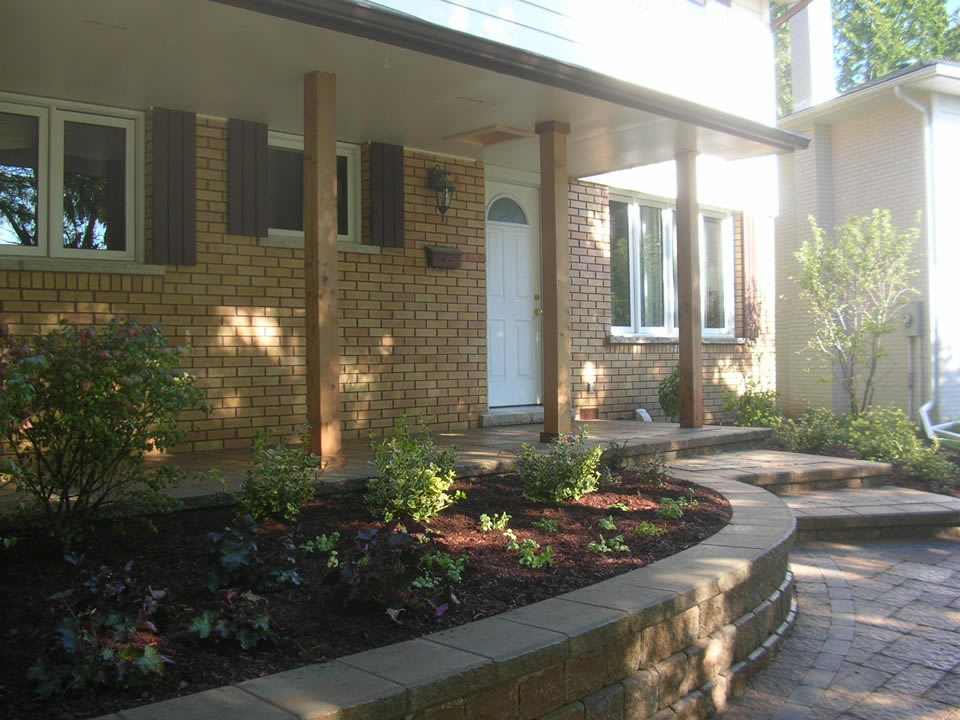 Concrete porch veneered with pavers, garden wall, walkway and steps