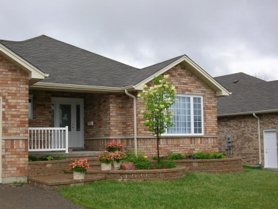 Entrance with tiered garden walls