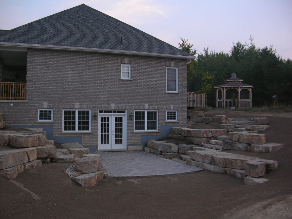 Walkout basement with limestone tiered retaining walls