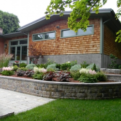 Planted curved garden retaining wall