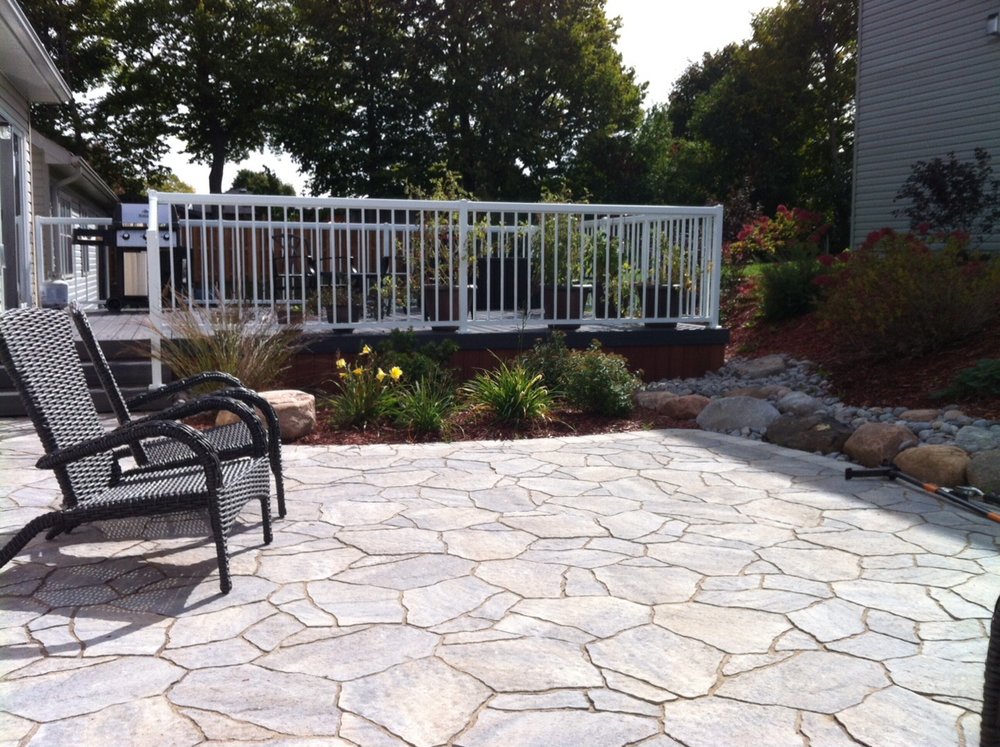 Mega Arbel patio, composite deck with Aluminum hand rail, and plantings