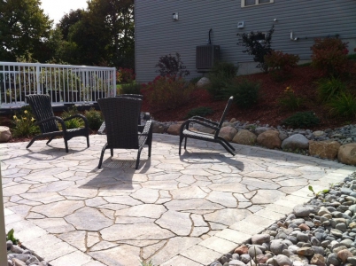 Mega Arbel patio with furniture, granite boulders and river rock