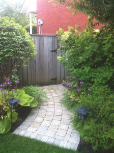 running bond, tumbled walkway with mature garden