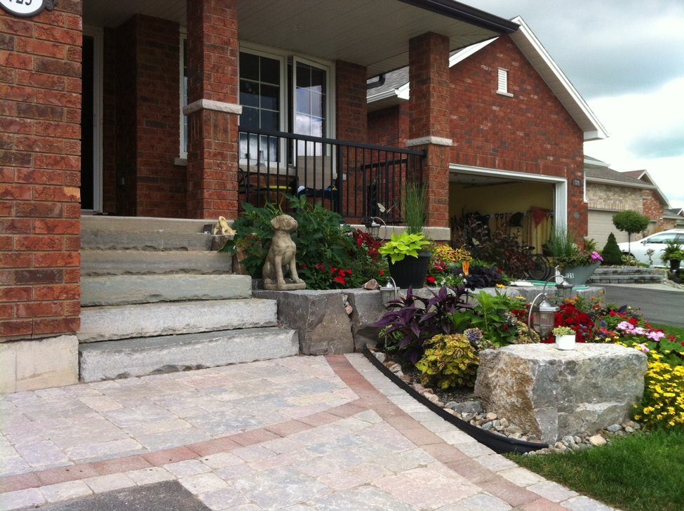 Natural stone steps with Armour stone planter wall and Interlocking stone apron